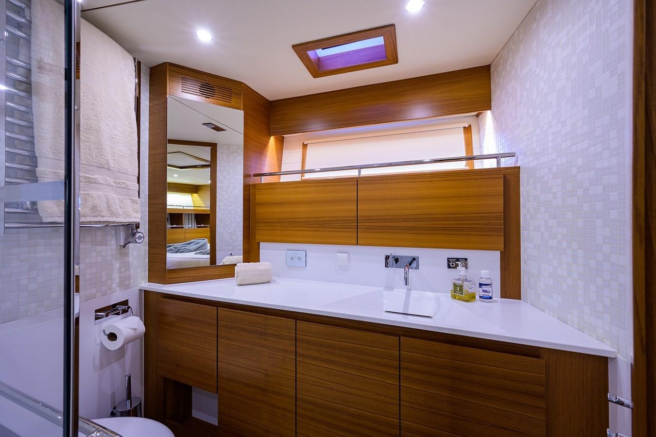 a bathroom with a sink and a mirror aboard CHREEDO Yacht for Sale