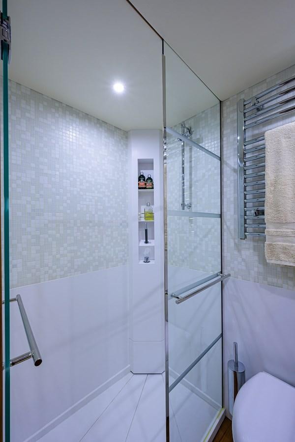 a bathroom with a glass shower aboard CHREEDO Yacht for Sale