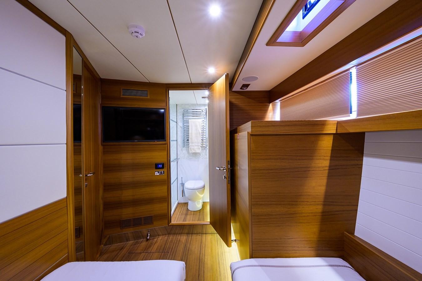 a bathroom with a toilet and a wooden door aboard CHREEDO Yacht for Sale