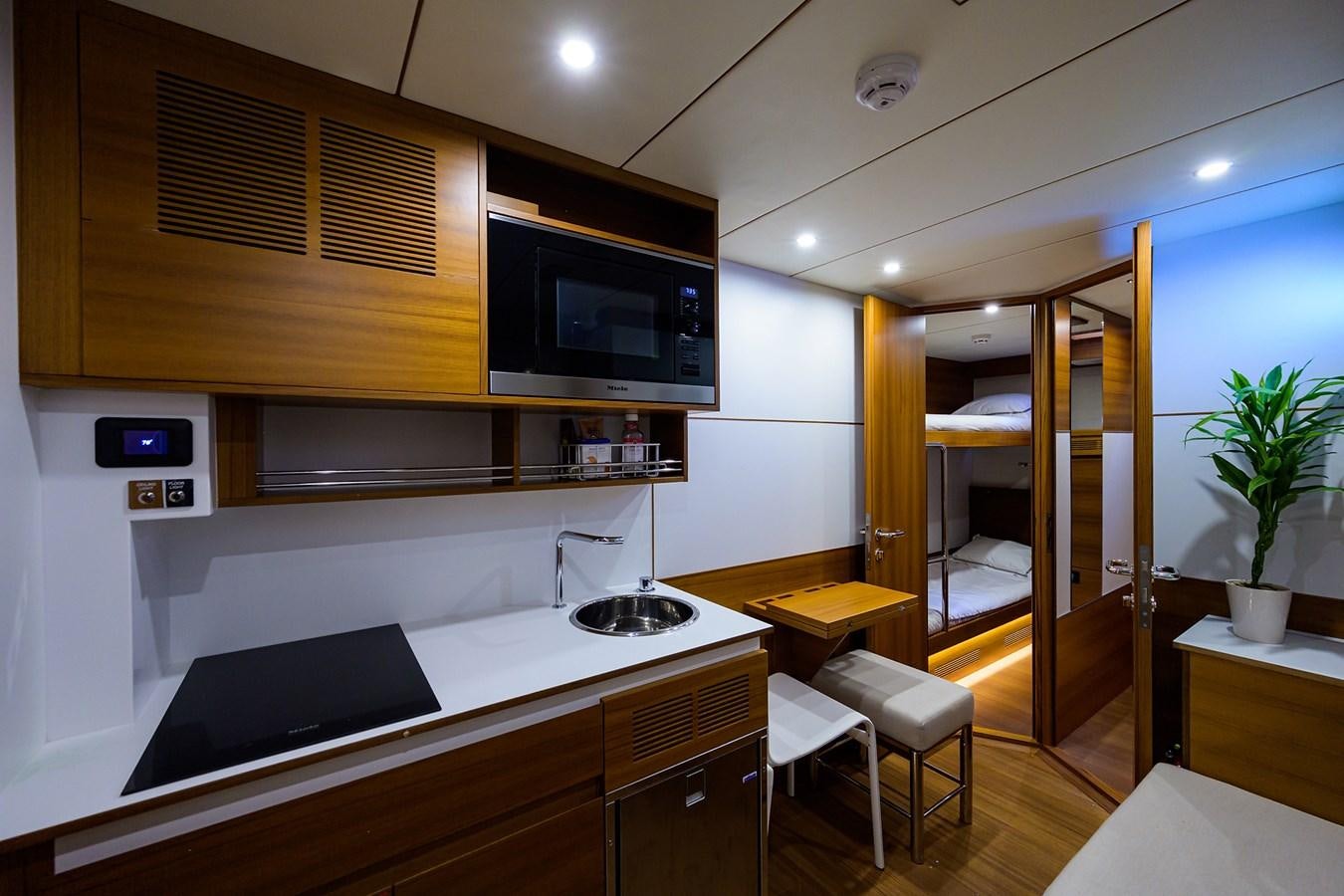 a kitchen with a large tv aboard CHREEDO Yacht for Sale