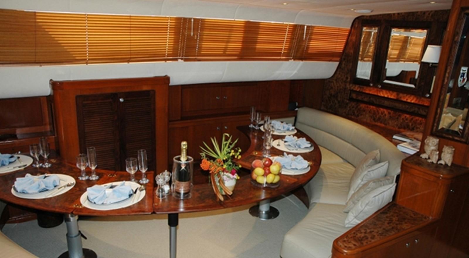 a living room with a table and chairs aboard SOUTHERN CROSS Yacht for Sale