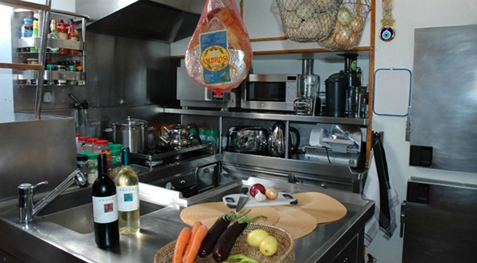 a kitchen with a countertop full of food and bottles aboard SOUTHERN CROSS Yacht for Sale