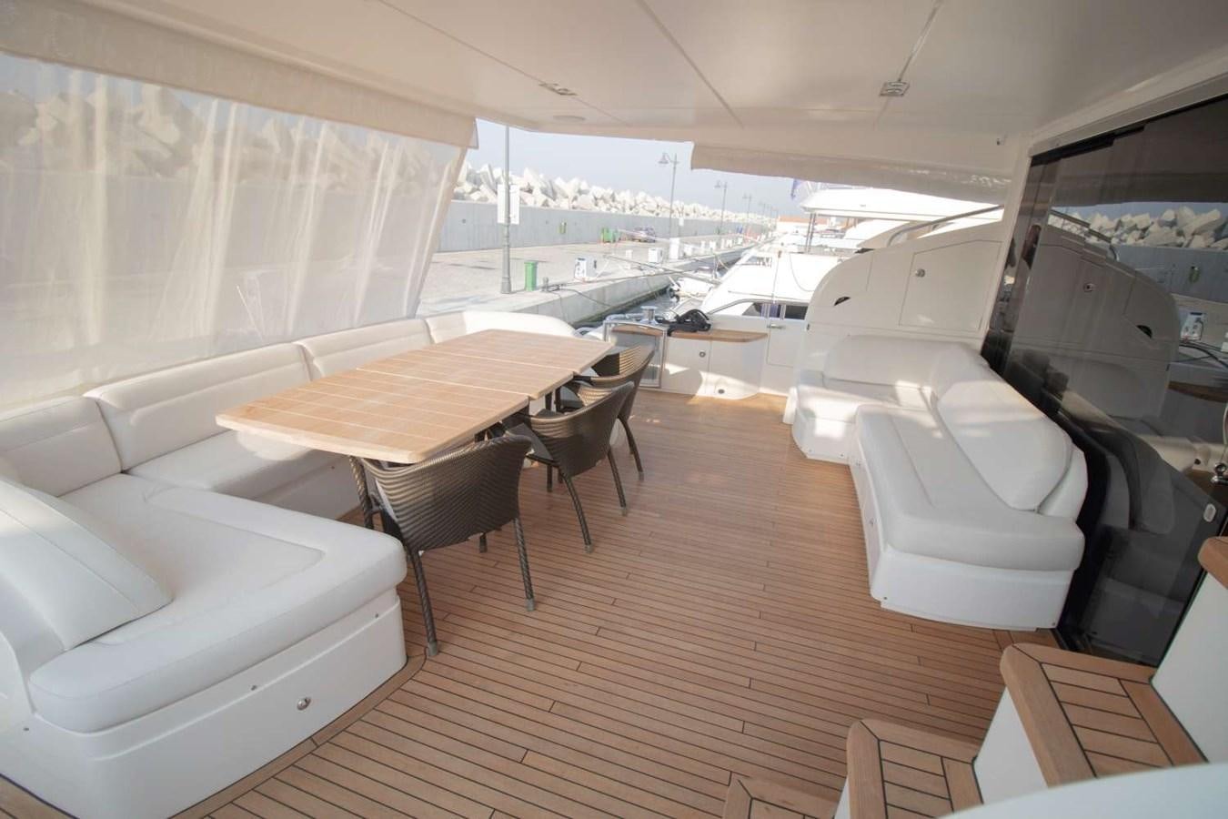 a room with a table chairs and a large window aboard ALLURE Yacht for Sale