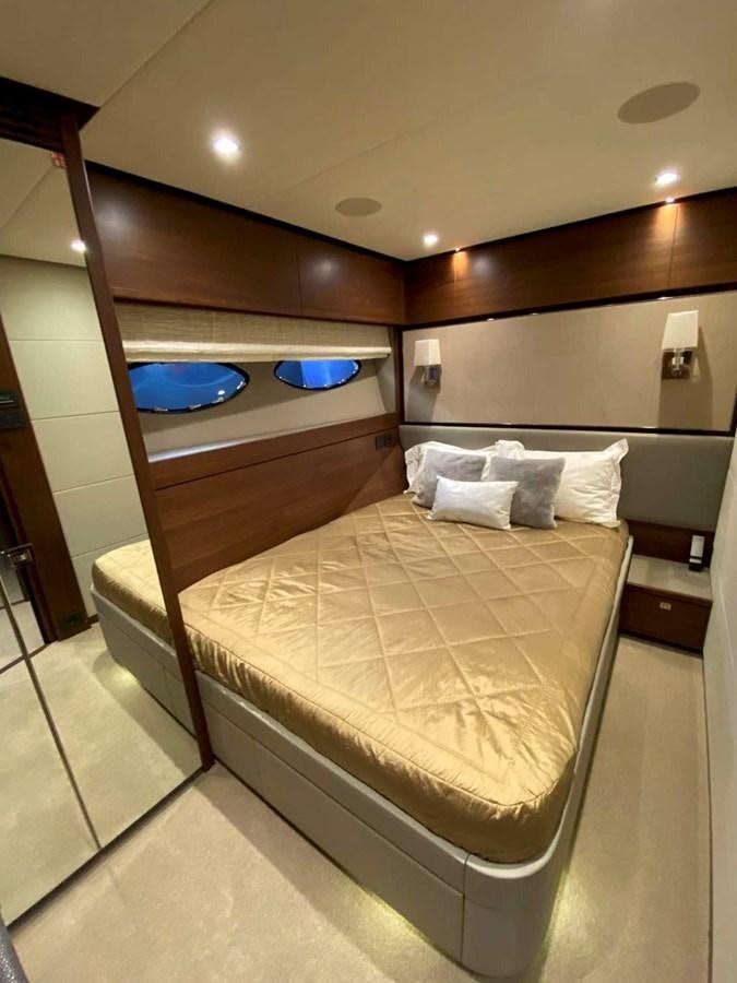 a bed with a mirror above it aboard ALLURE Yacht for Sale