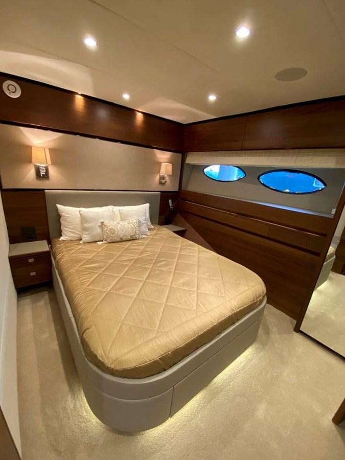 a bed with a large mirror above it aboard ALLURE Yacht for Sale
