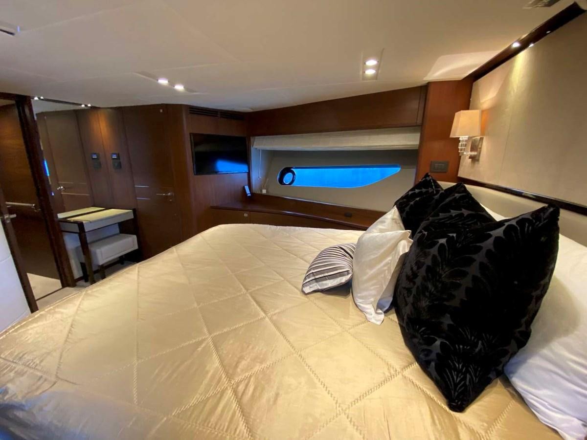 a hotel room with a bed and a tv aboard ALLURE Yacht for Sale