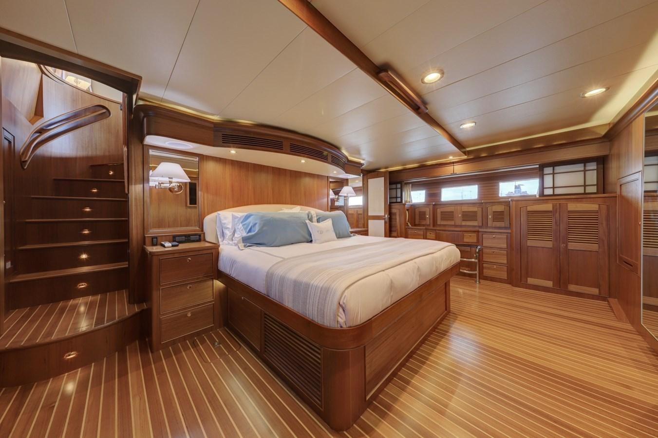 a bedroom with a wood floor aboard ONE LIFE Yacht for Sale