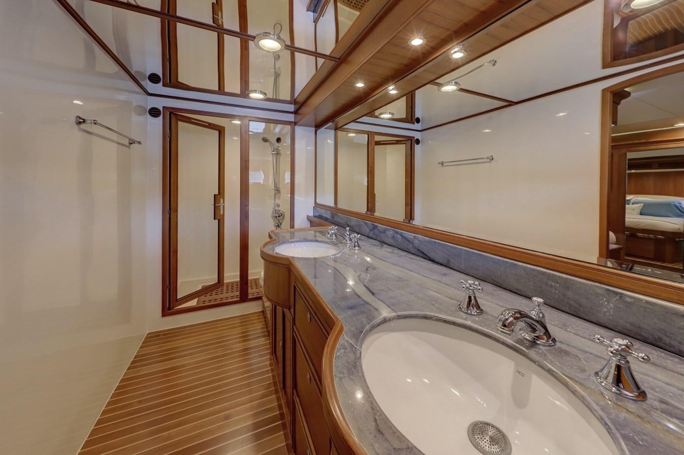 a bathroom with a countertop sink and mirrors aboard ONE LIFE Yacht for Sale