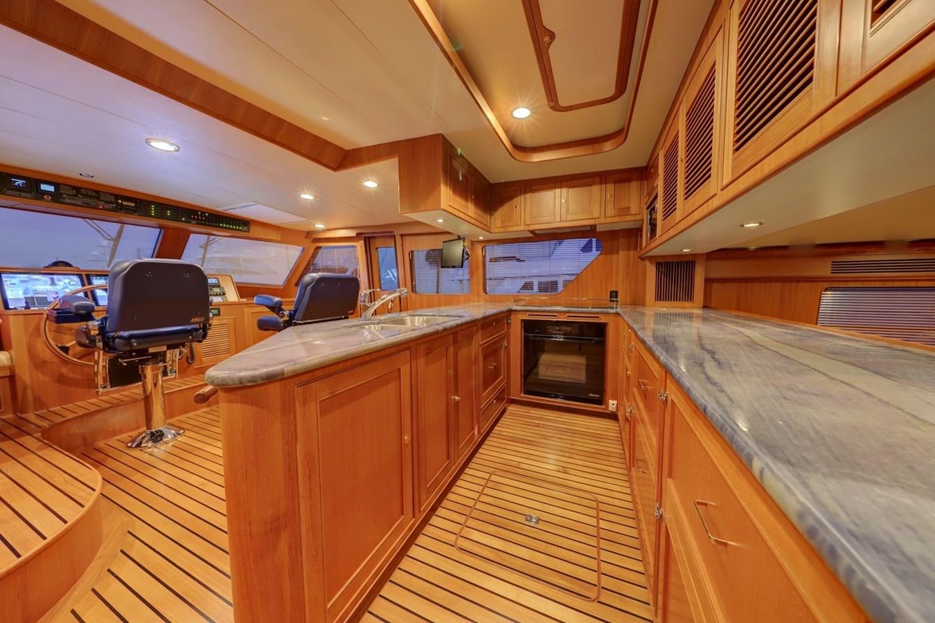 a large kitchen with wooden cabinets aboard ONE LIFE Yacht for Sale