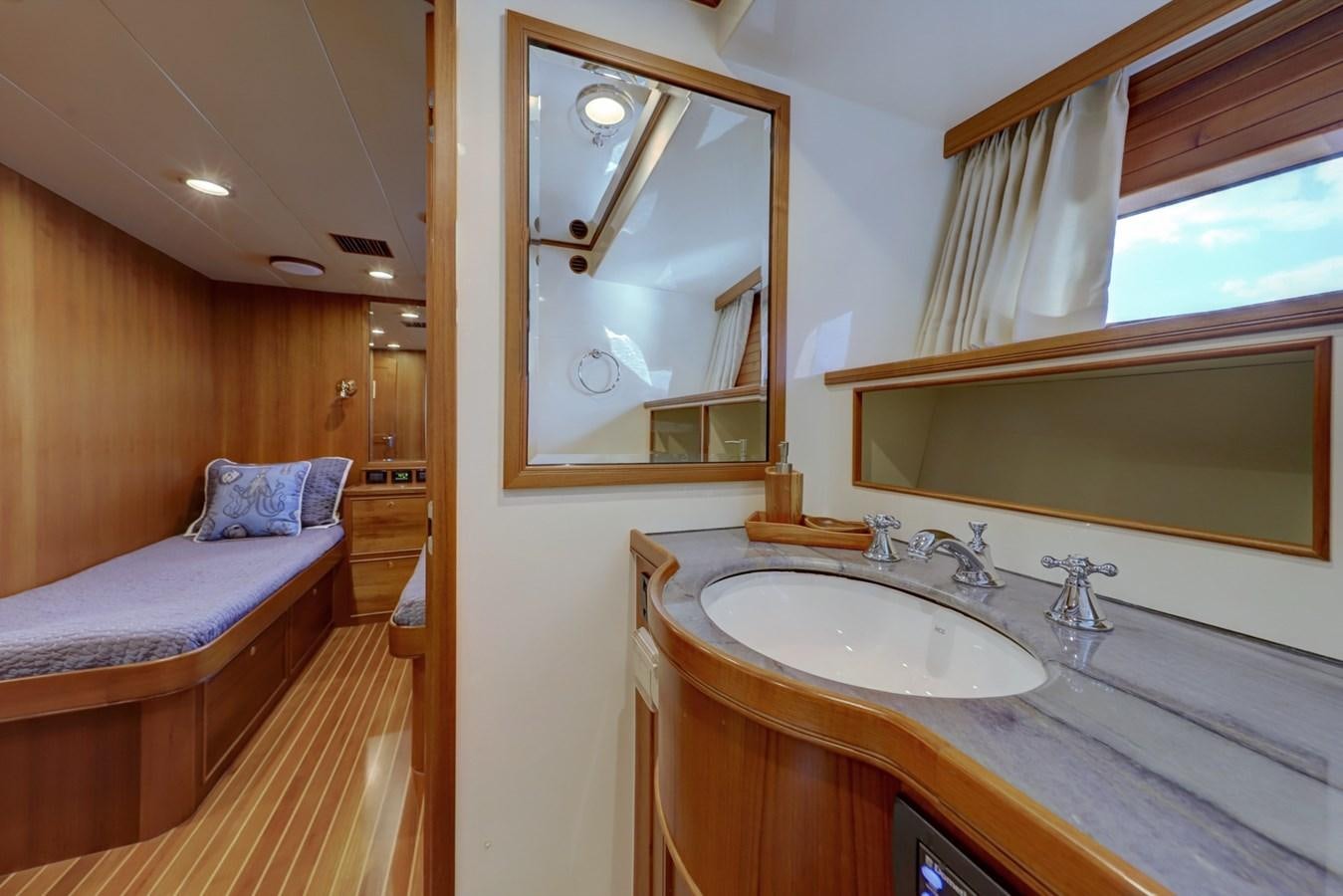 a bathroom with a sink and a bed aboard ONE LIFE Yacht for Sale