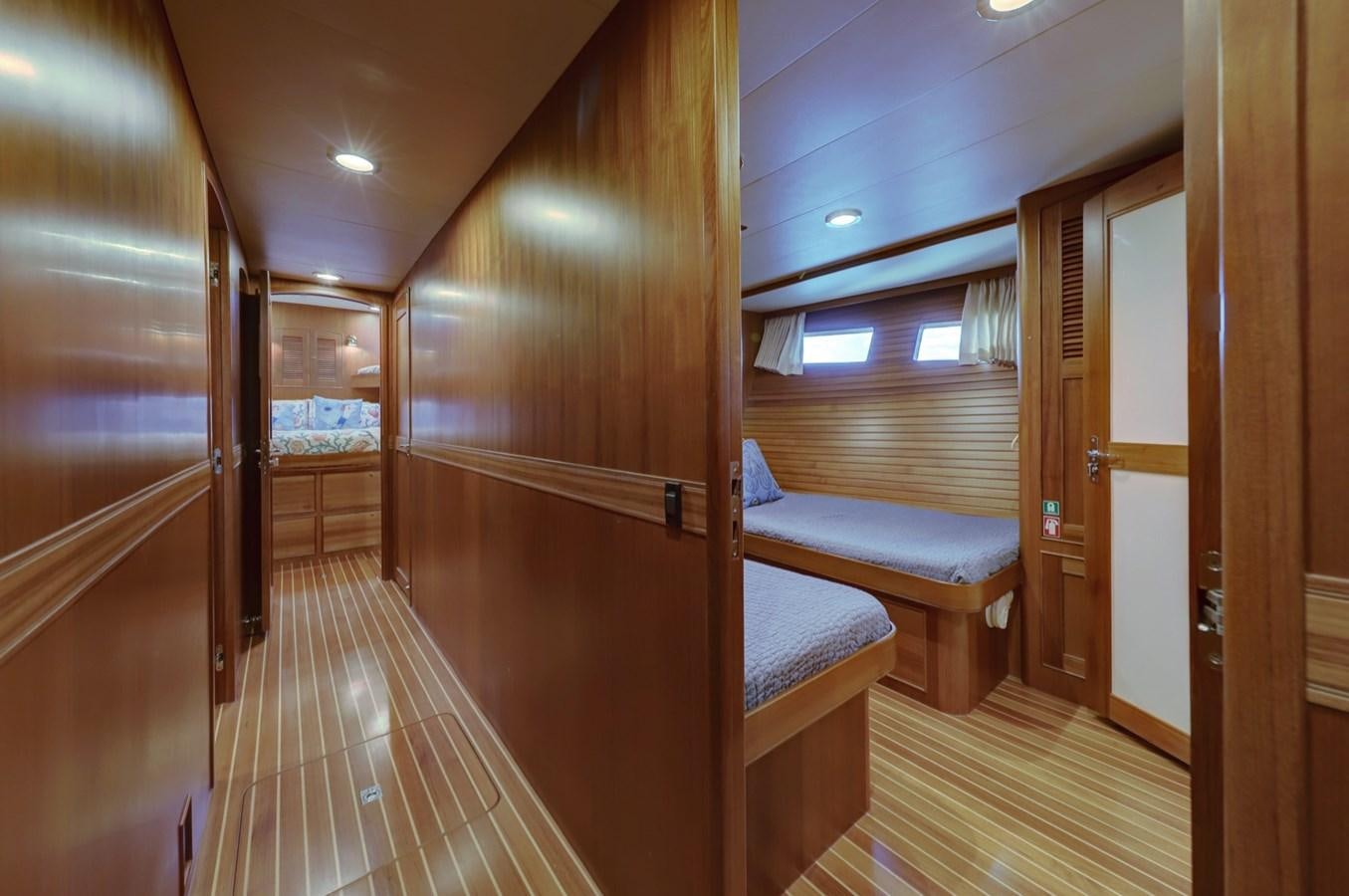 a room with wooden walls and wooden doors aboard ONE LIFE Yacht for Sale