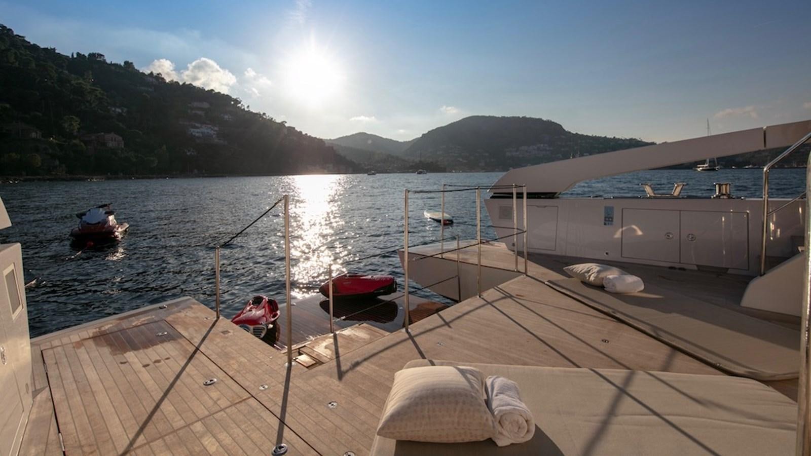 a deck with a view of a mountain and a body of water aboard SANLORENZO SL86/678 Yacht for Sale