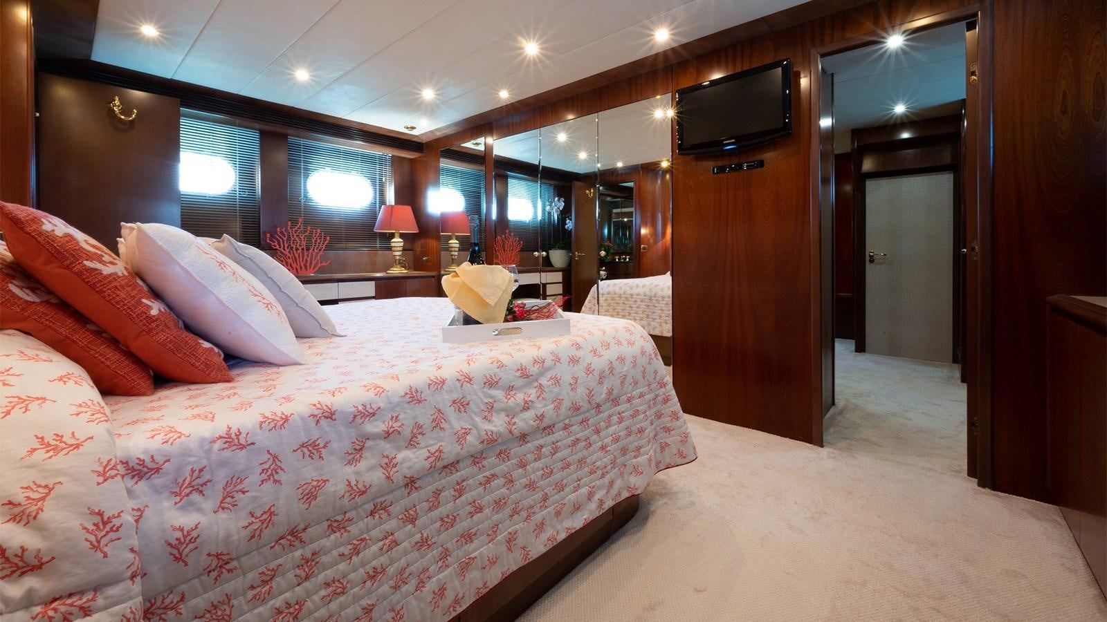 a room with a bed and a television aboard FIRST LADY II Yacht for Sale