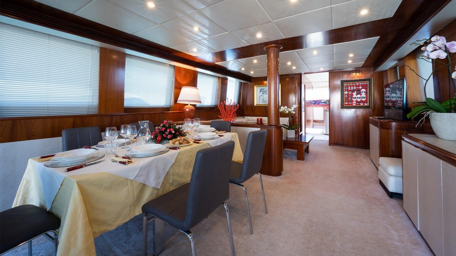 a large room with a table and chairs aboard FIRST LADY II Yacht for Sale