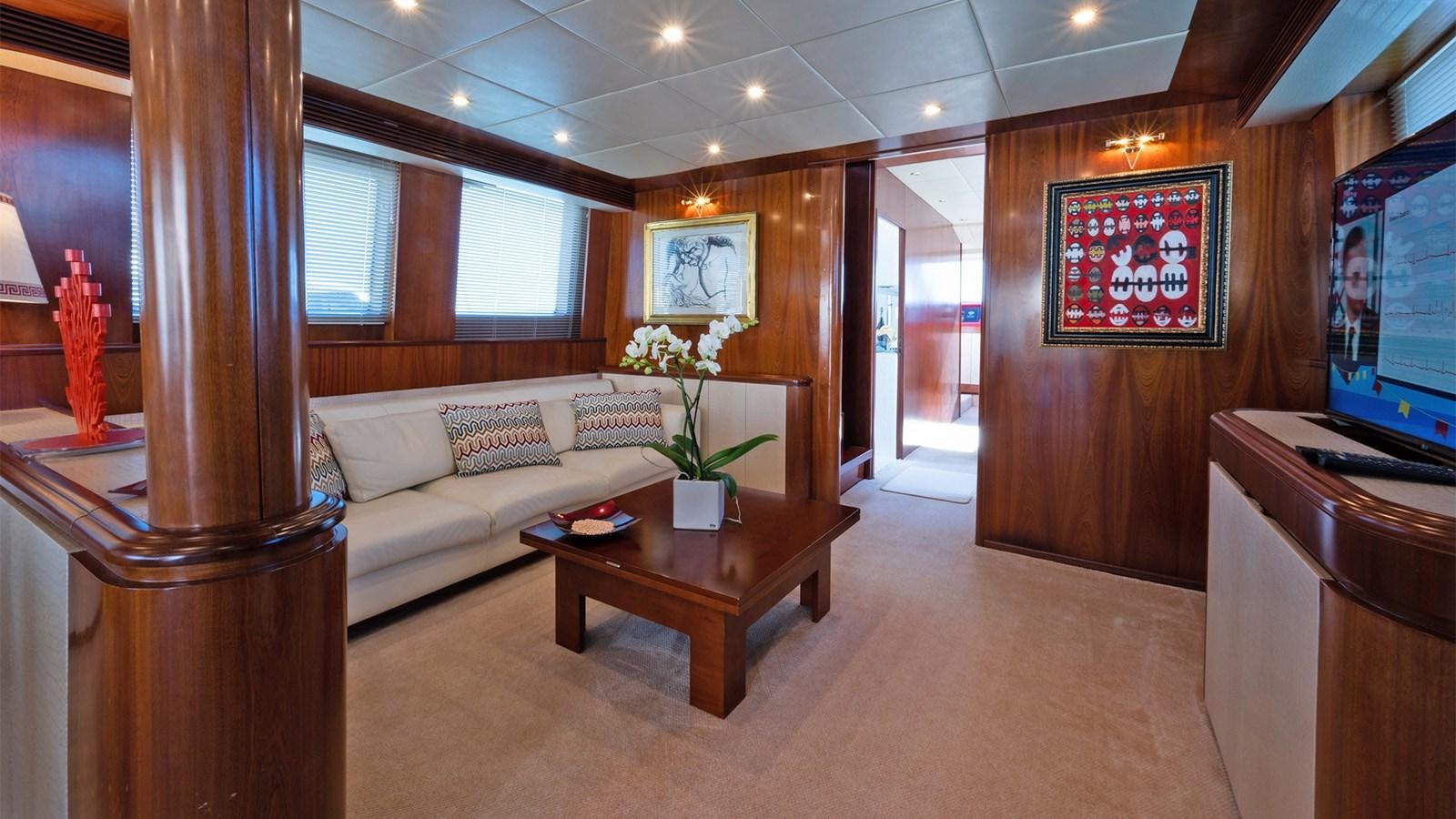 a living room with a couch and a television aboard FIRST LADY II Yacht for Sale