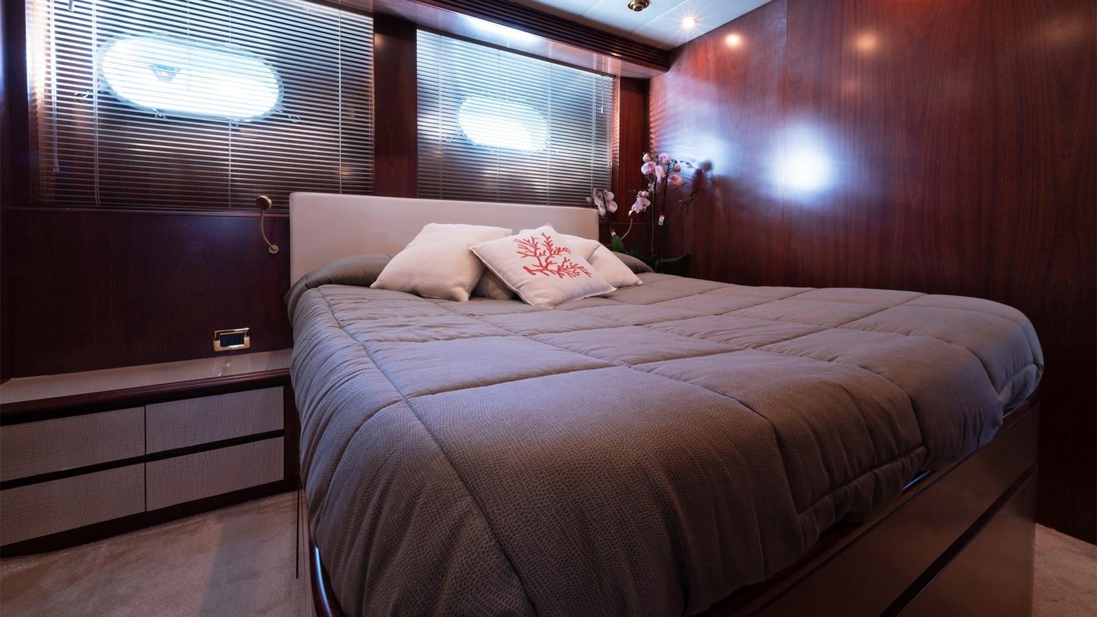a bed with a white comforter aboard FIRST LADY II Yacht for Sale