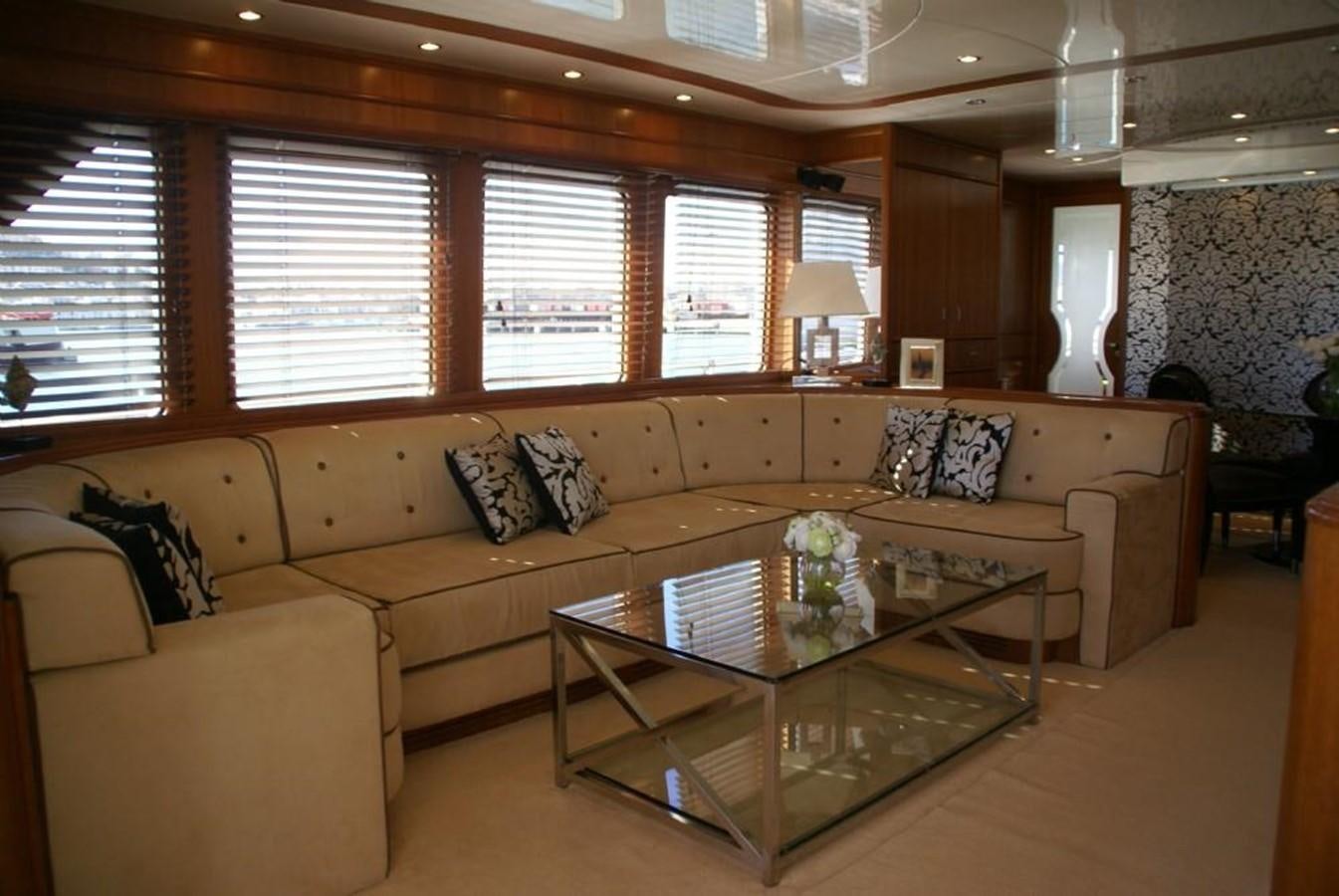 a living room with a couch and a coffee table aboard AMANZI Yacht for Sale