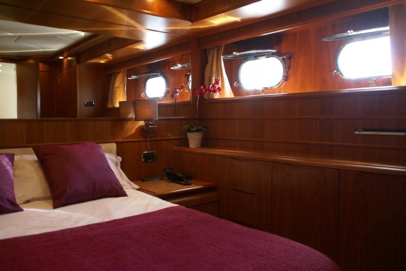 a bed with pink sheets aboard AMANZI Yacht for Sale