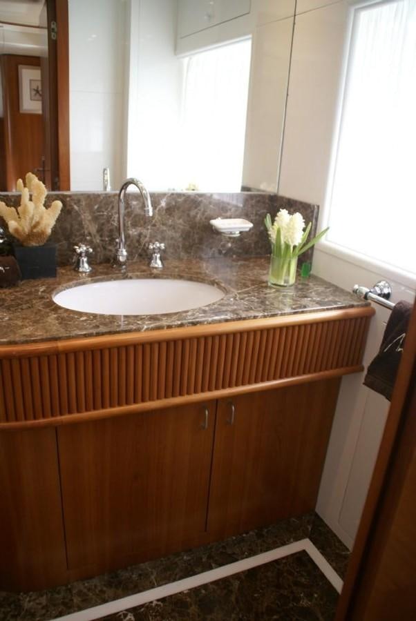 a bathroom sink with a flower vase aboard AMANZI Yacht for Sale