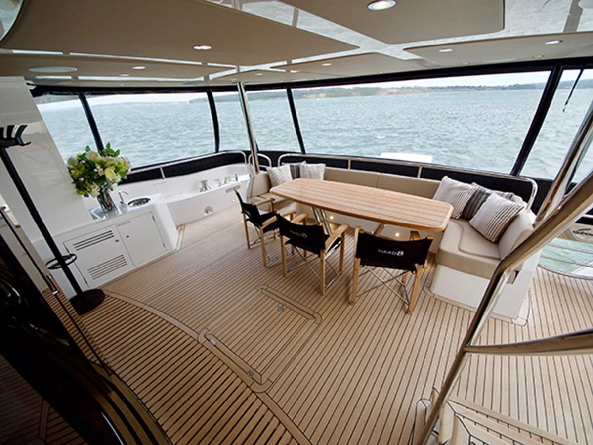 a room with a table and chairs aboard LADY O Yacht for Sale