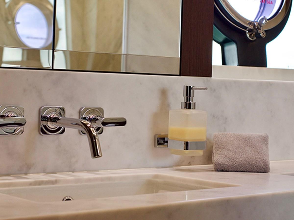 a bathroom with a sink and mirror aboard LADY O Yacht for Sale
