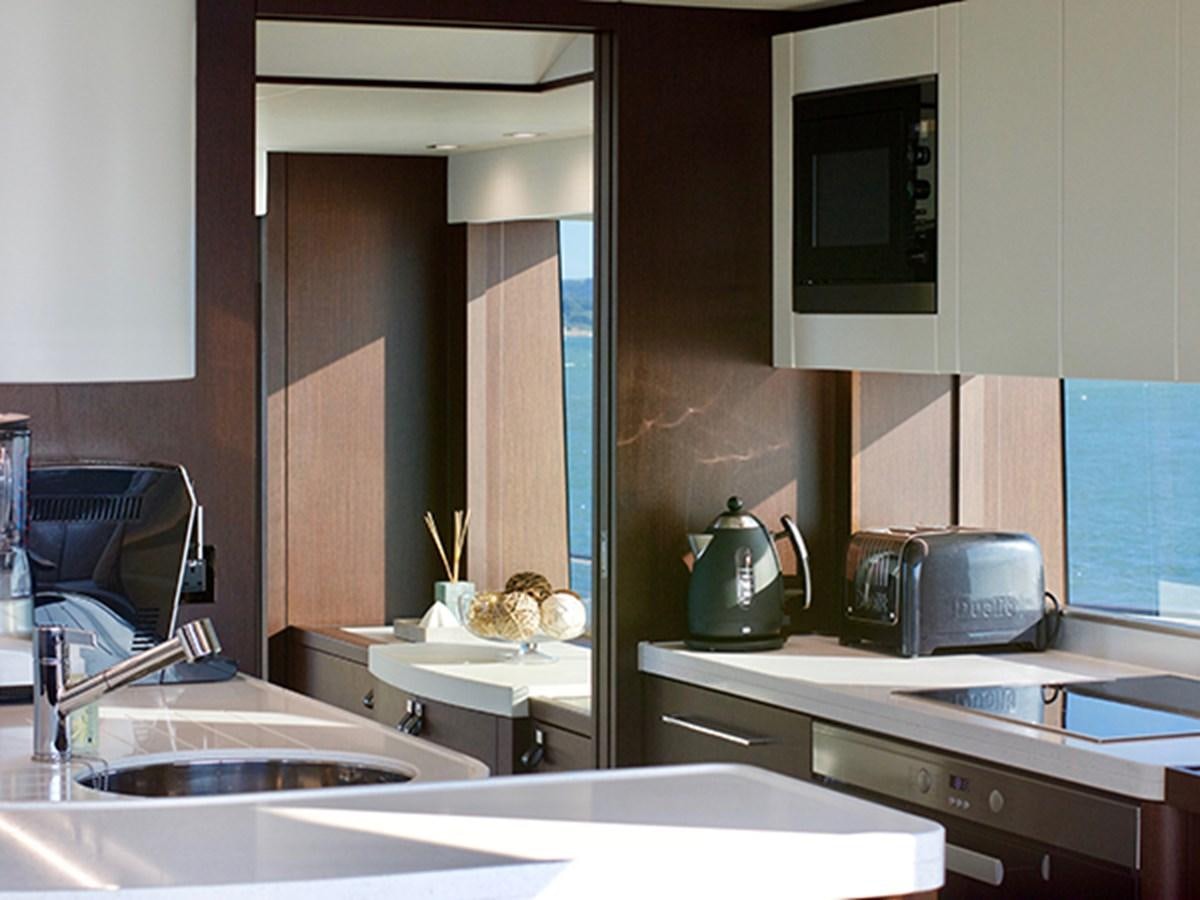 a kitchen with a sink and a microwave aboard LADY O Yacht for Sale