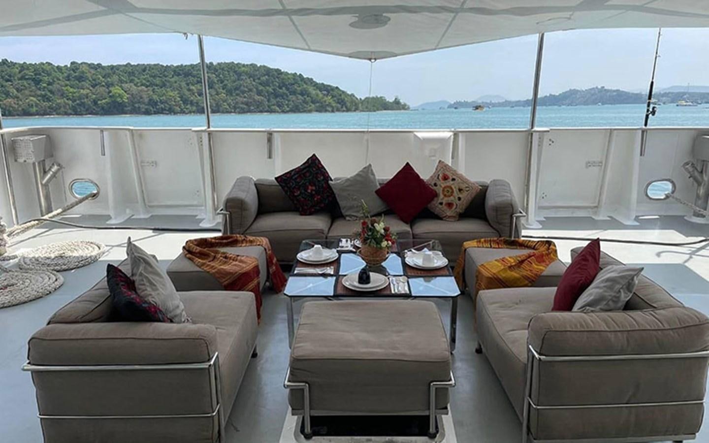 a living room with a couch and a table aboard KAMA BAY Yacht for Sale
