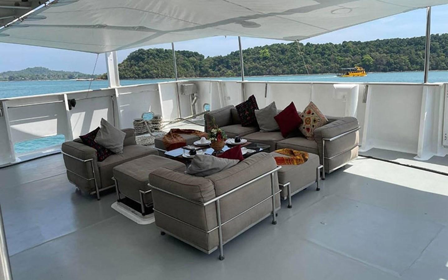 a living room with a couch and a table aboard KAMA BAY Yacht for Sale