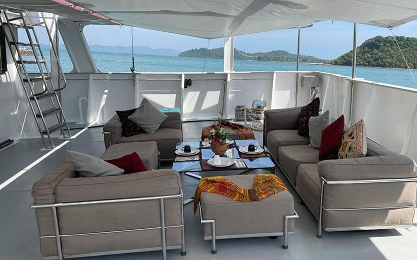 a living room with a large glass window aboard KAMA BAY Yacht for Sale
