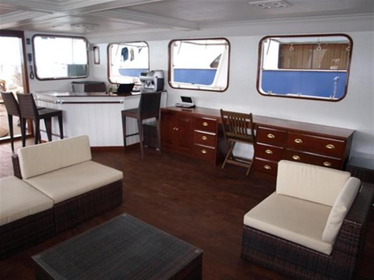 a room with a couch and a table and chairs aboard KAMA BAY Yacht for Sale