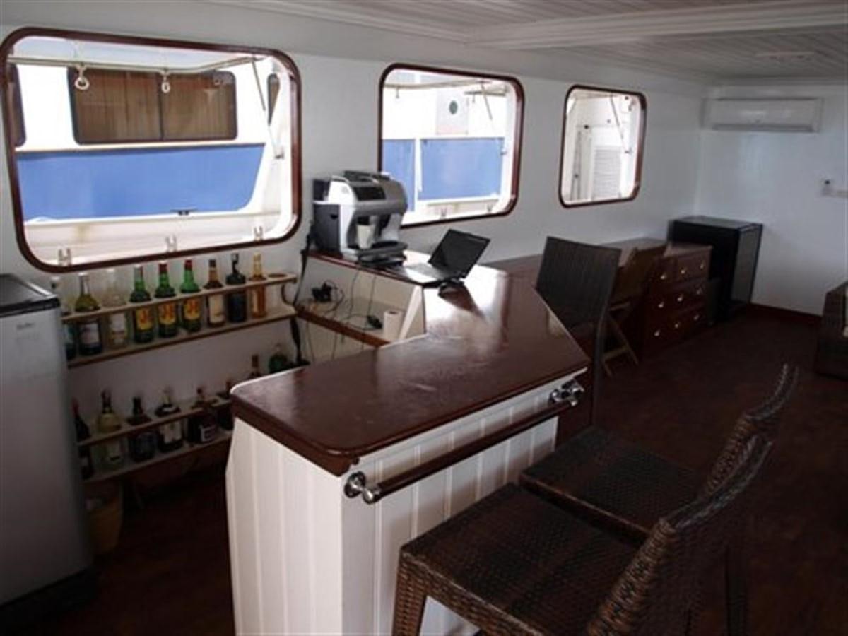 a room with a table and chairs aboard KAMA BAY Yacht for Sale