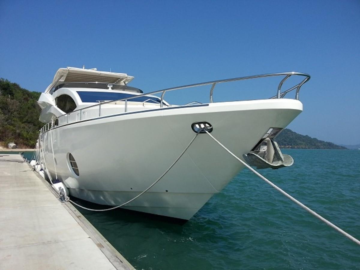 a white boat on a dock aboard MY JAYA Yacht for Sale