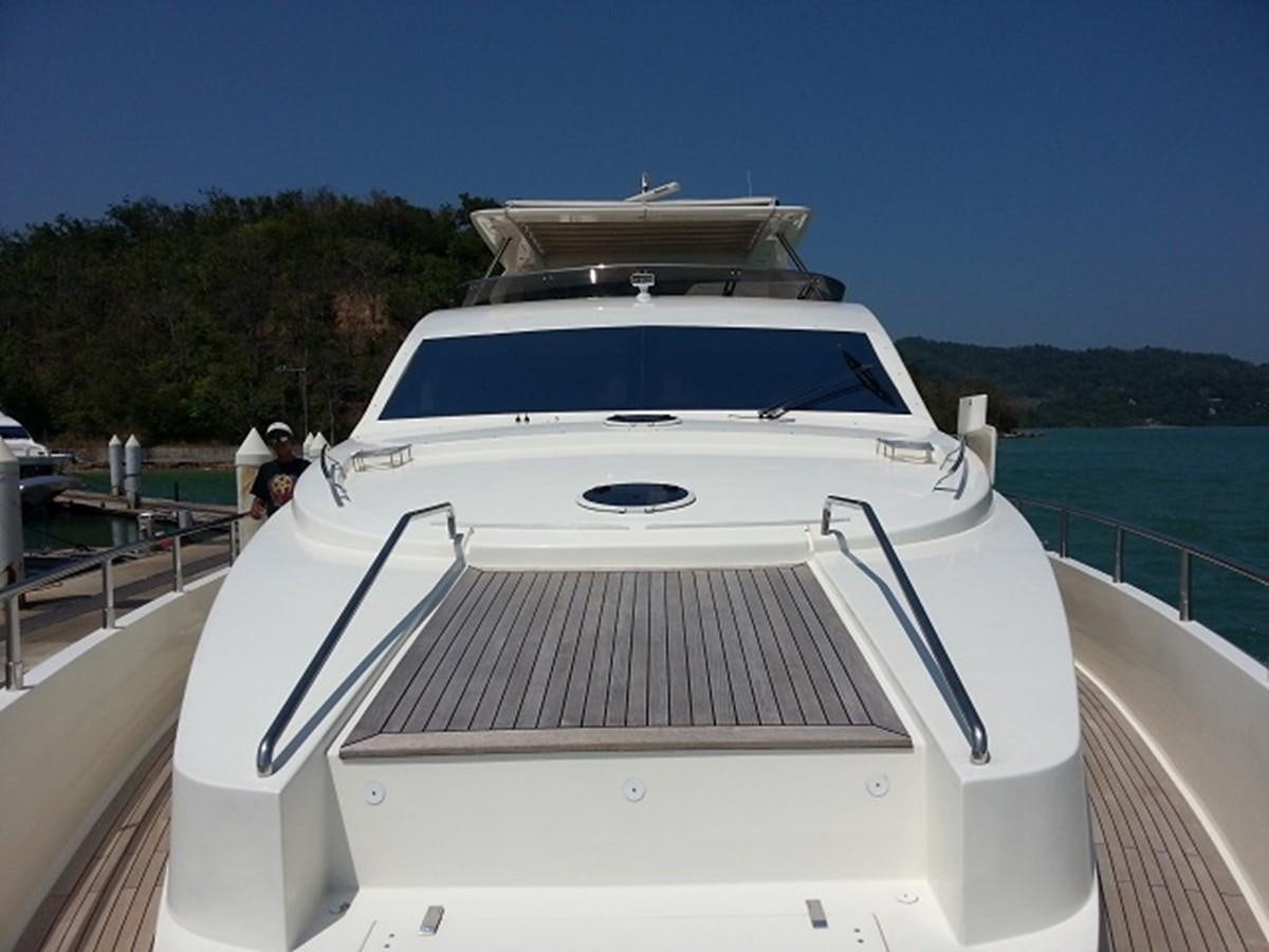 a white boat on a dock aboard MY JAYA Yacht for Sale