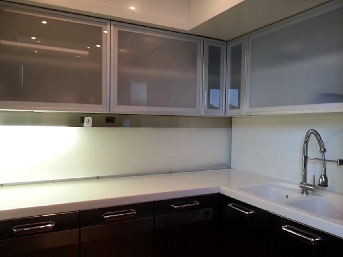 a kitchen with white cabinets aboard MY JAYA Yacht for Sale