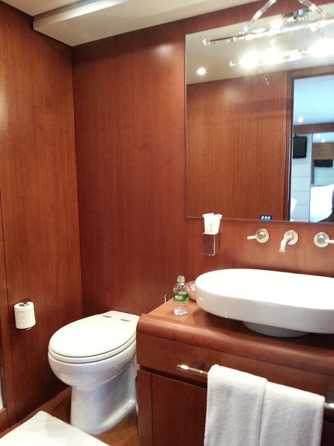 a bathroom with a sink toilet and a mirror aboard MY JAYA Yacht for Sale