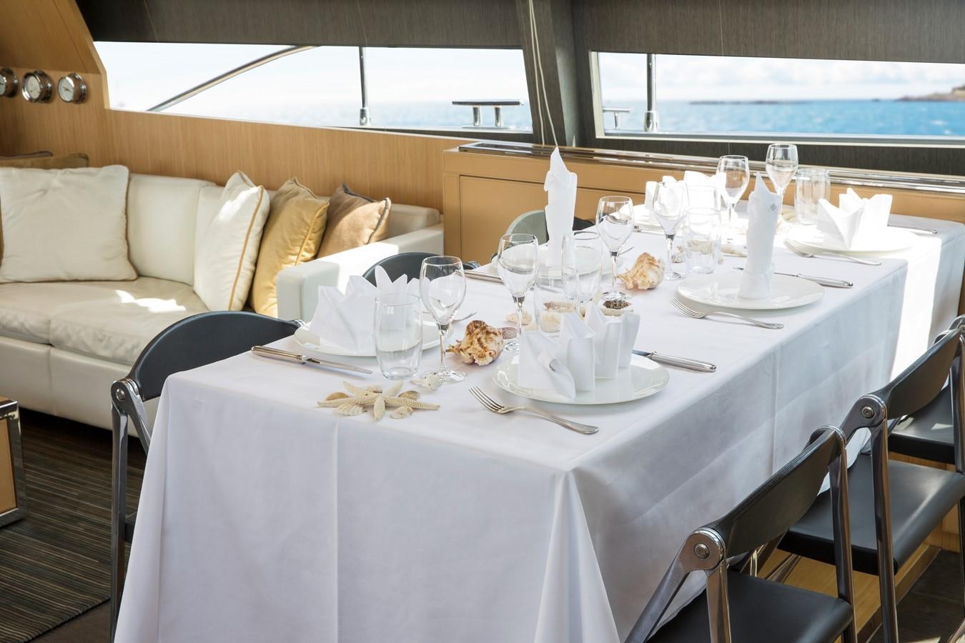 a table set for a dinner aboard RHINO A Yacht for Sale