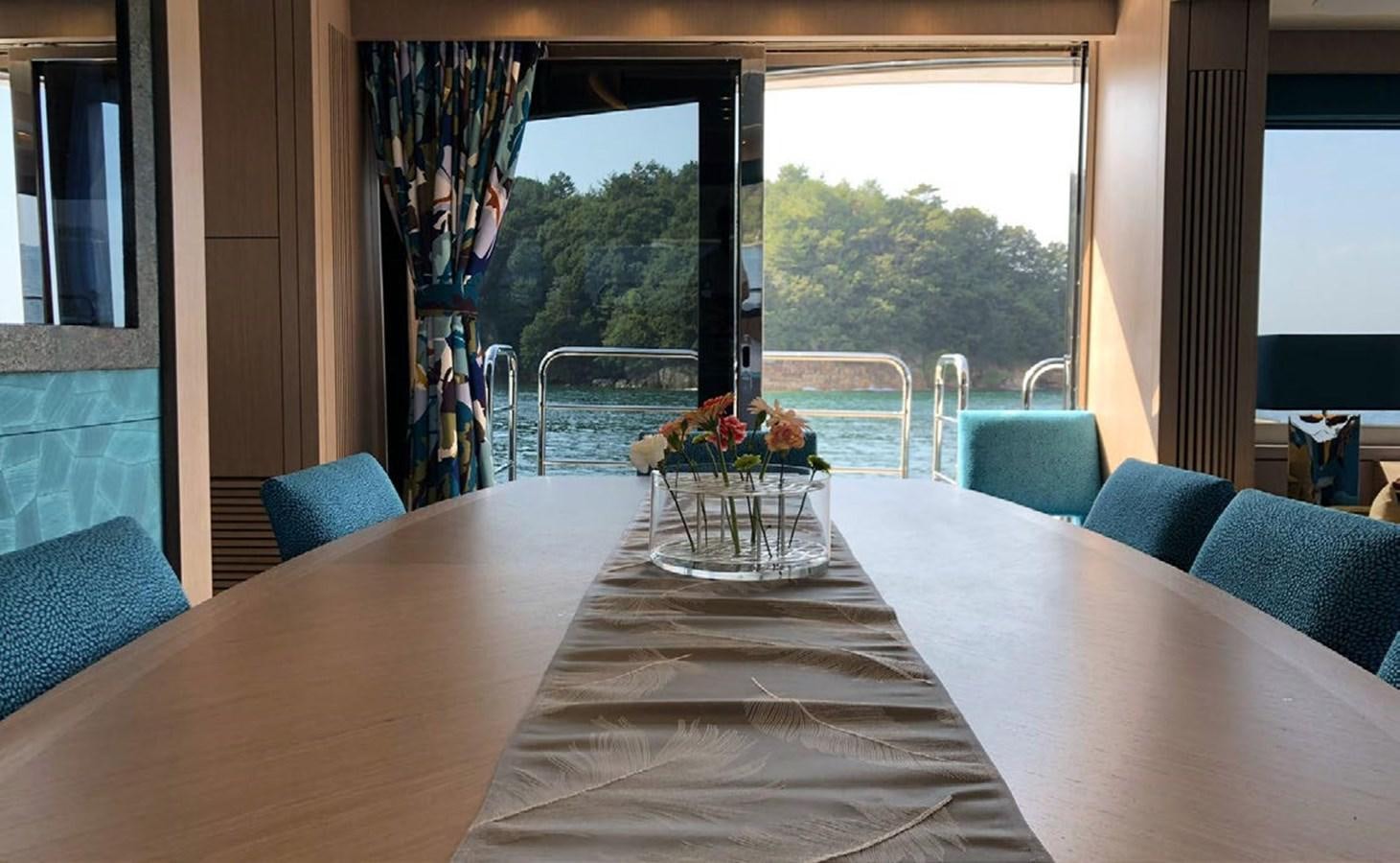 a table with a vase of flowers on it aboard SKYE Yacht for Sale