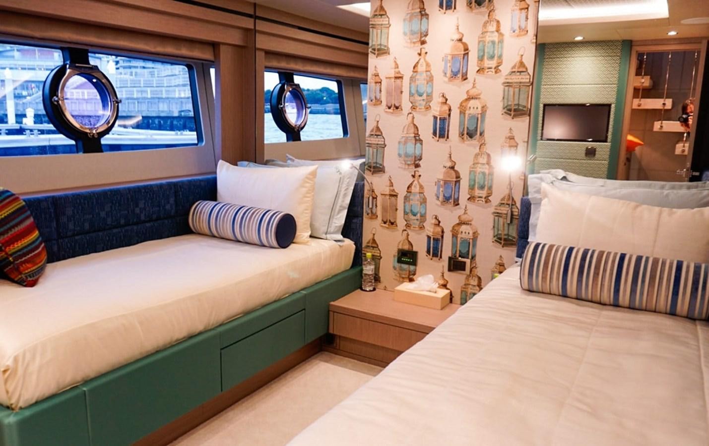 a room with a bed and a mirror aboard SKYE Yacht for Sale