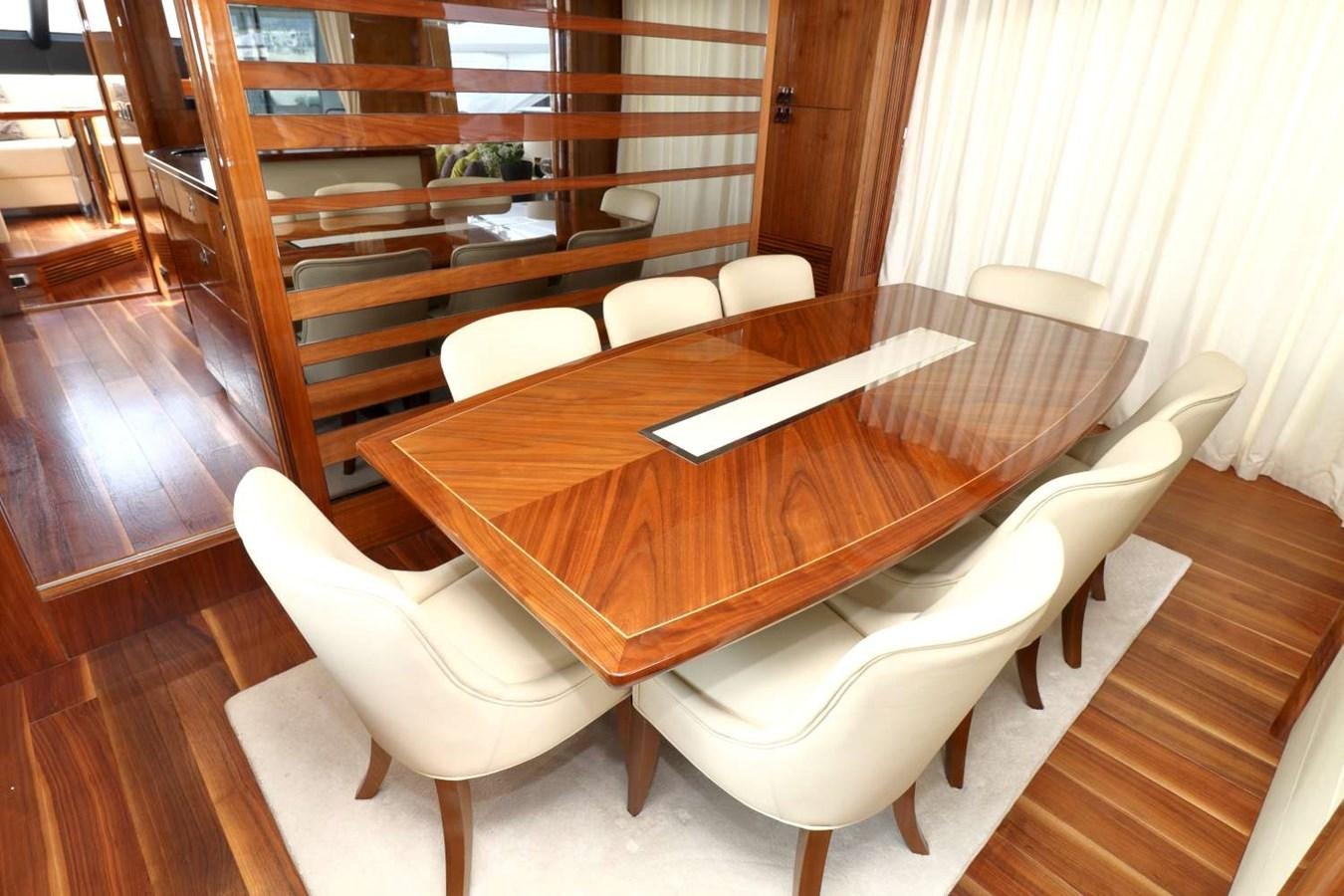 a room with a table and chairs aboard SUNSEEKER 86 Yacht for Sale