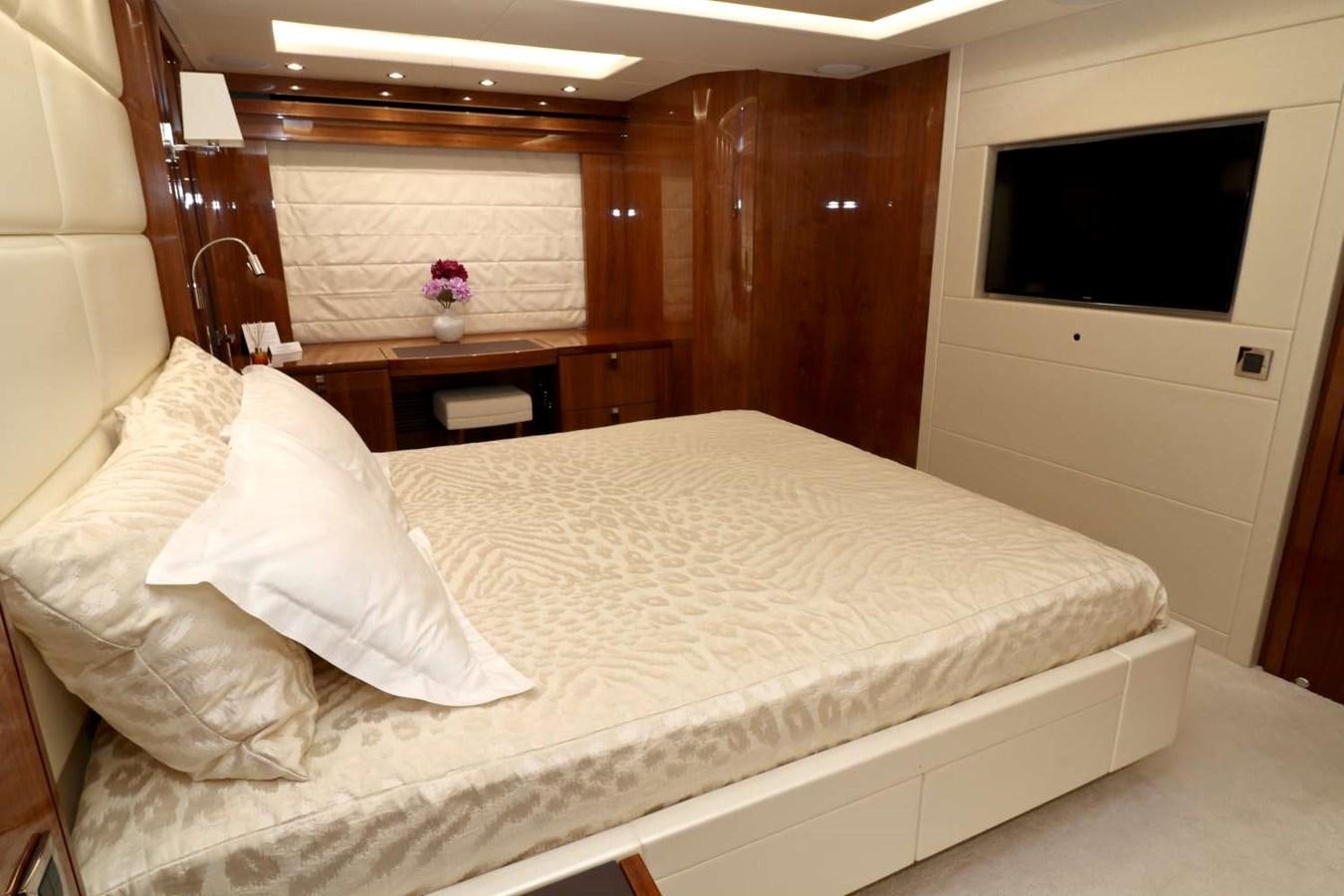 a bed with white sheets aboard SUNSEEKER 86 Yacht for Sale