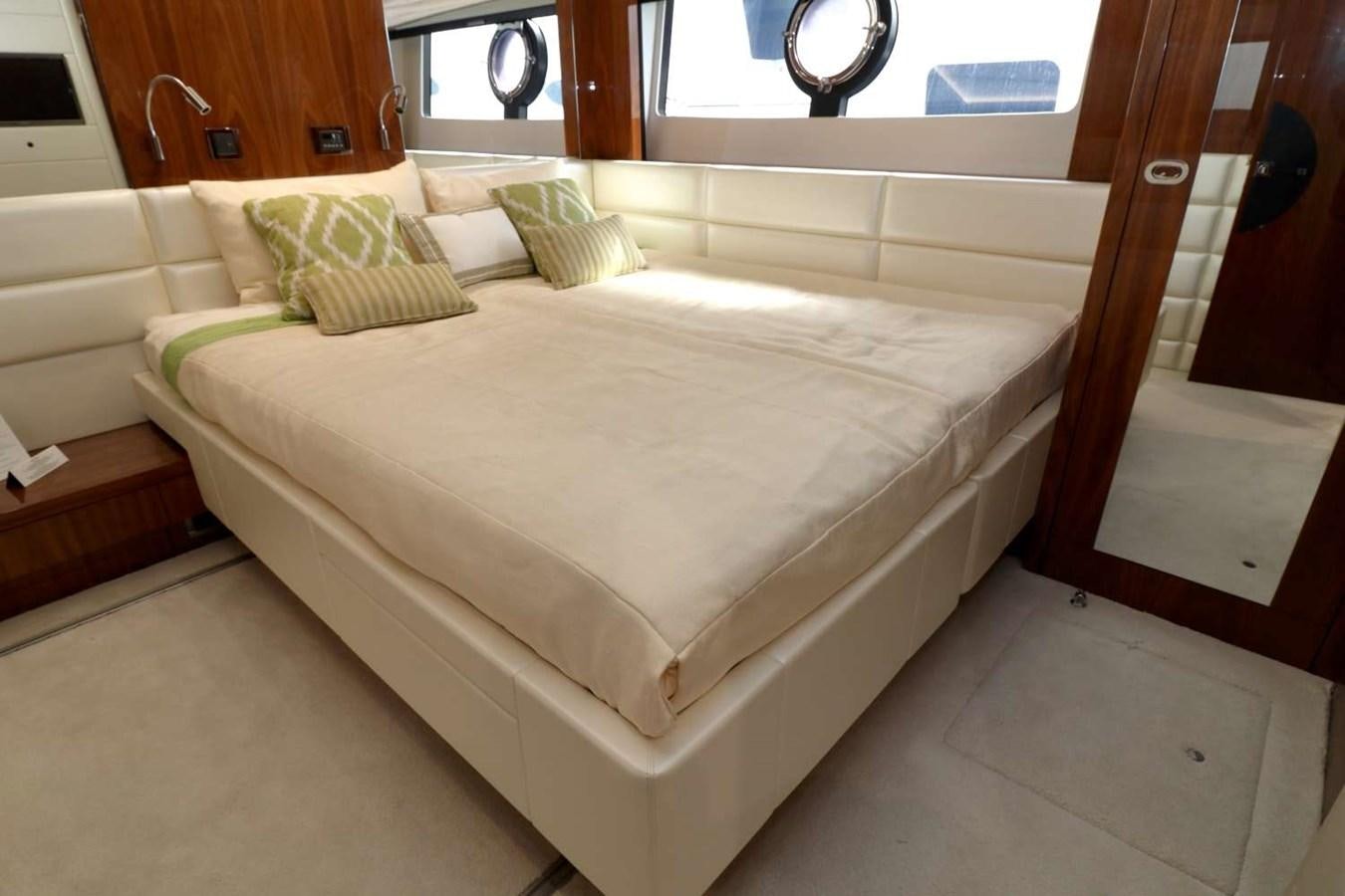 a bed with a white sheet aboard SUNSEEKER 86 Yacht for Sale