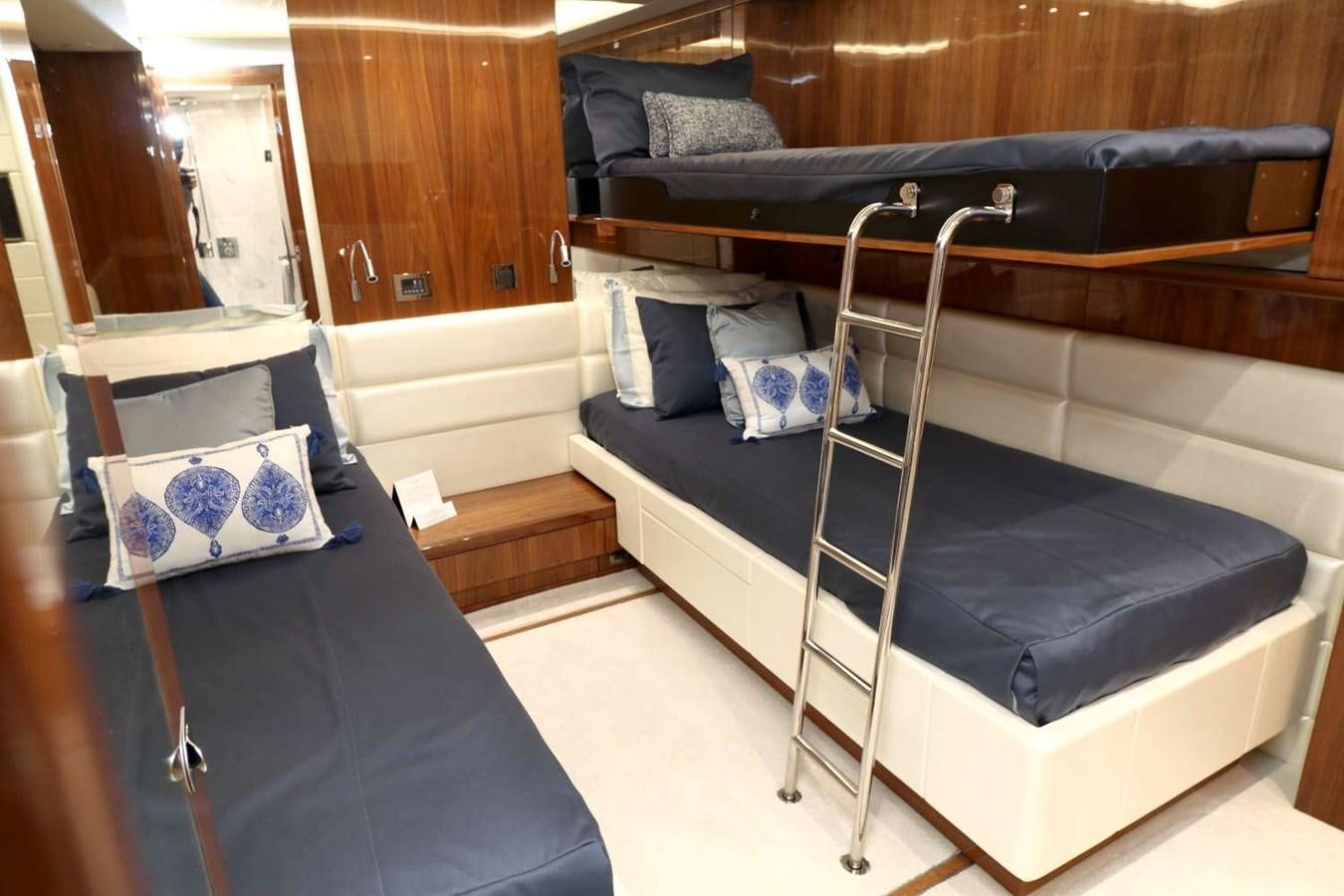 a bed with a blue sheet aboard SUNSEEKER 86 Yacht for Sale