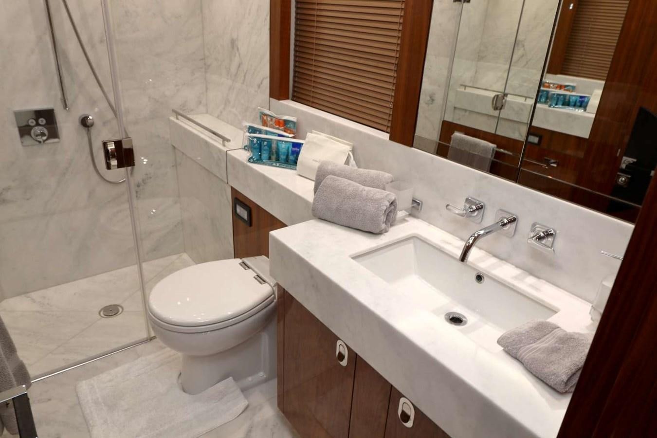 a bathroom with a sink toilet and a shower aboard SUNSEEKER 86 Yacht for Sale