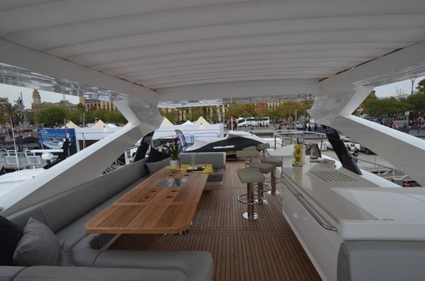 a room with a wood table and chairs and a large window with a view of the city and aboard SUNSEEKER 86 Yacht for Sale