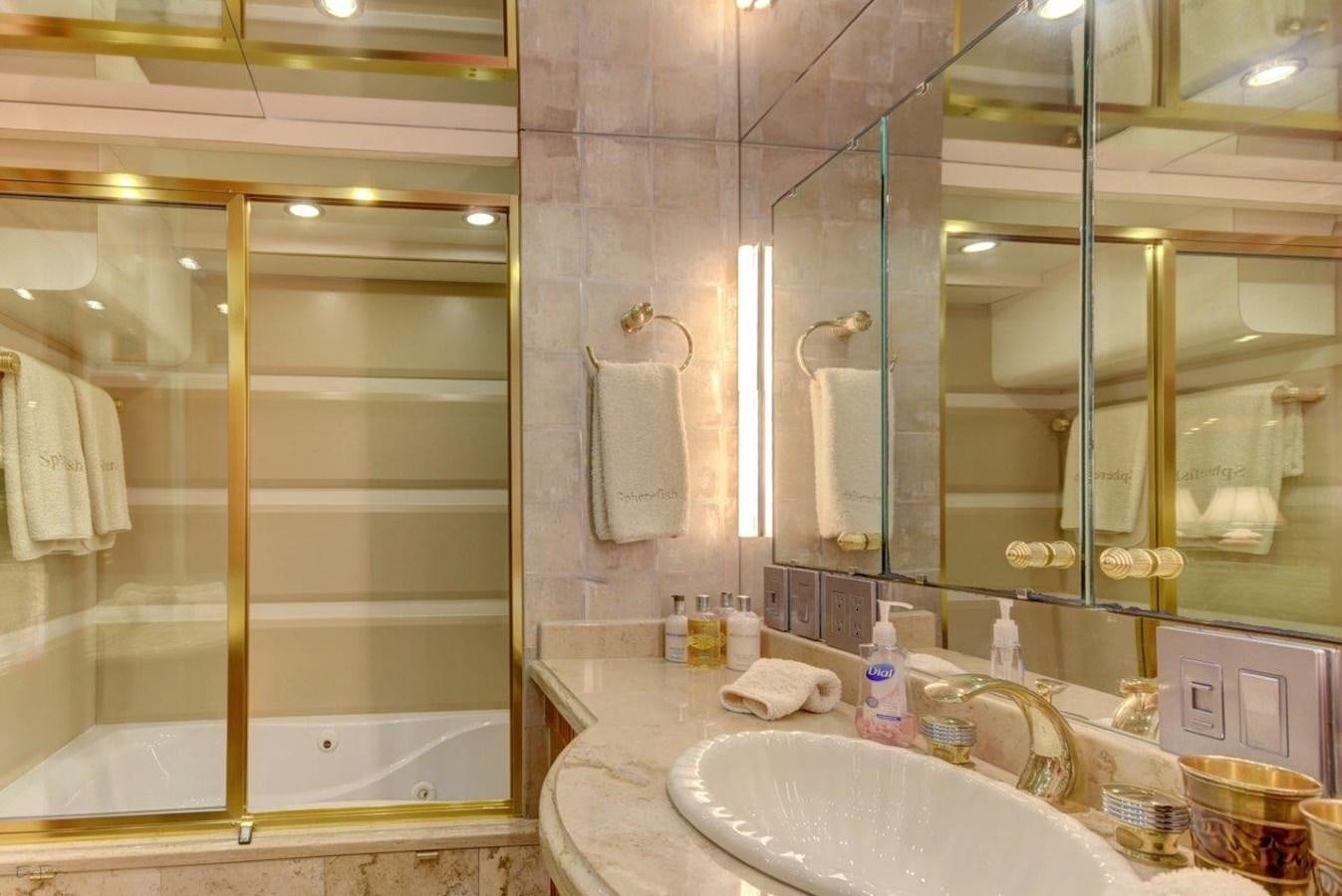 a bathroom with a glass shower aboard SPHEREFISH Yacht for Sale