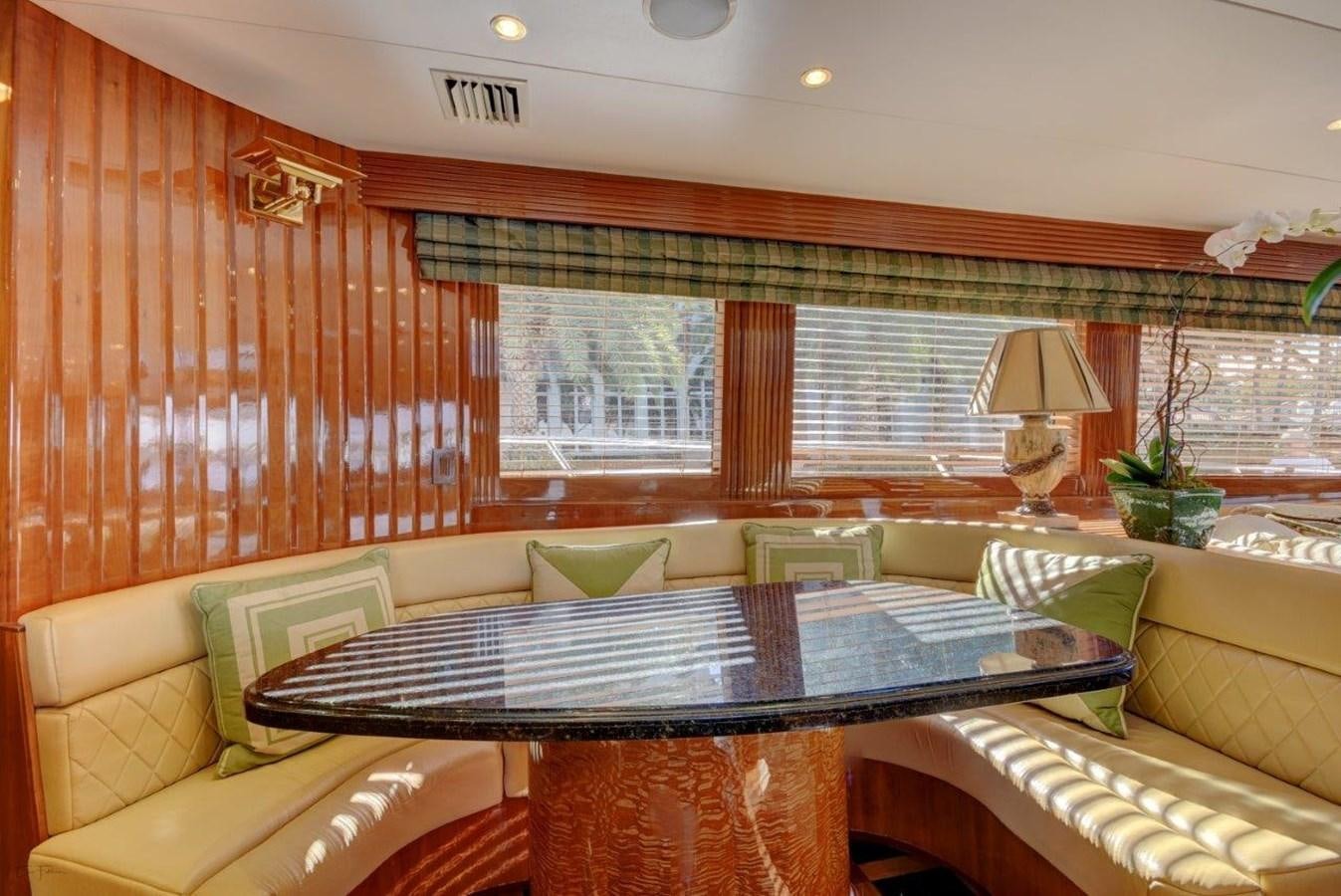 a room with a table and chairs aboard SPHEREFISH Yacht for Sale