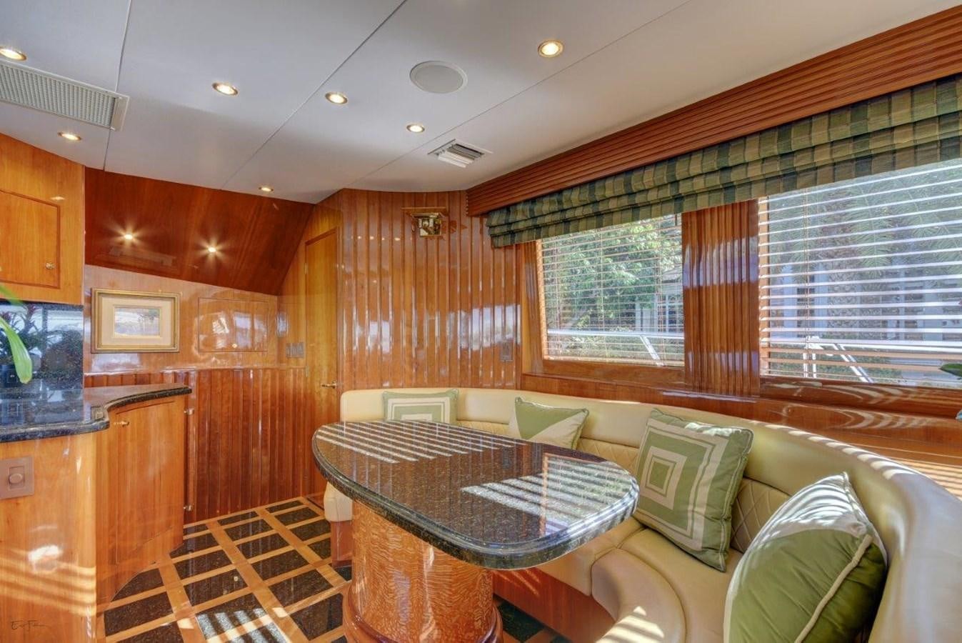 a room with a table and chairs aboard SPHEREFISH Yacht for Sale