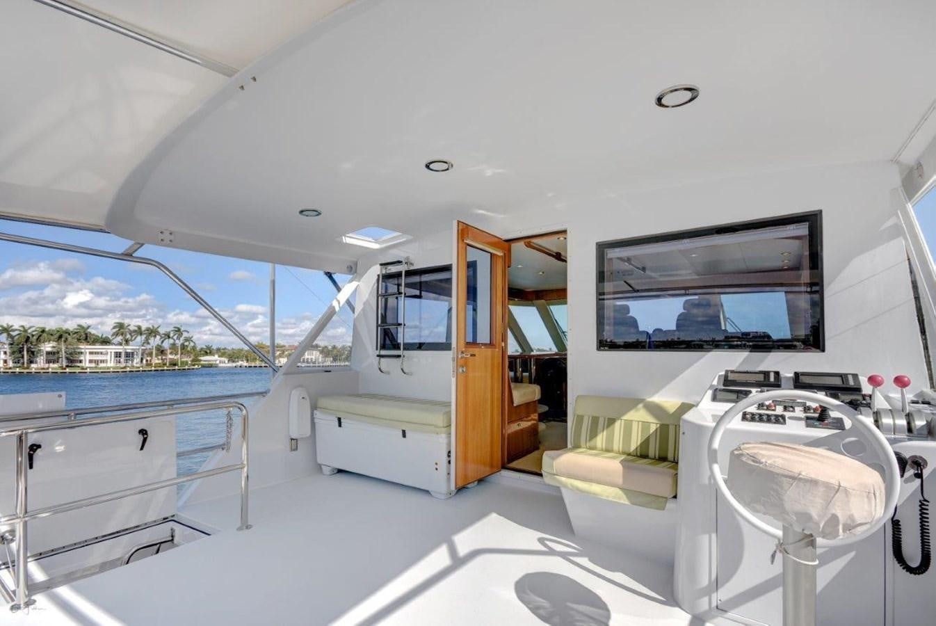 a room with a large window and a large television aboard SPHEREFISH Yacht for Sale