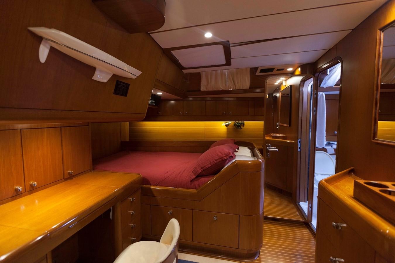 a bedroom with a bed and desk aboard DREAMLAND Yacht for Sale