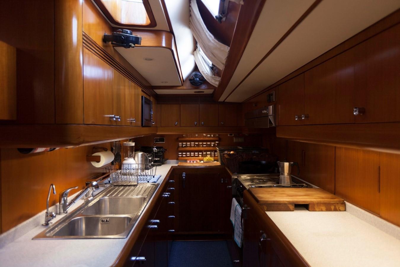 a kitchen with wooden cabinets aboard DREAMLAND Yacht for Sale